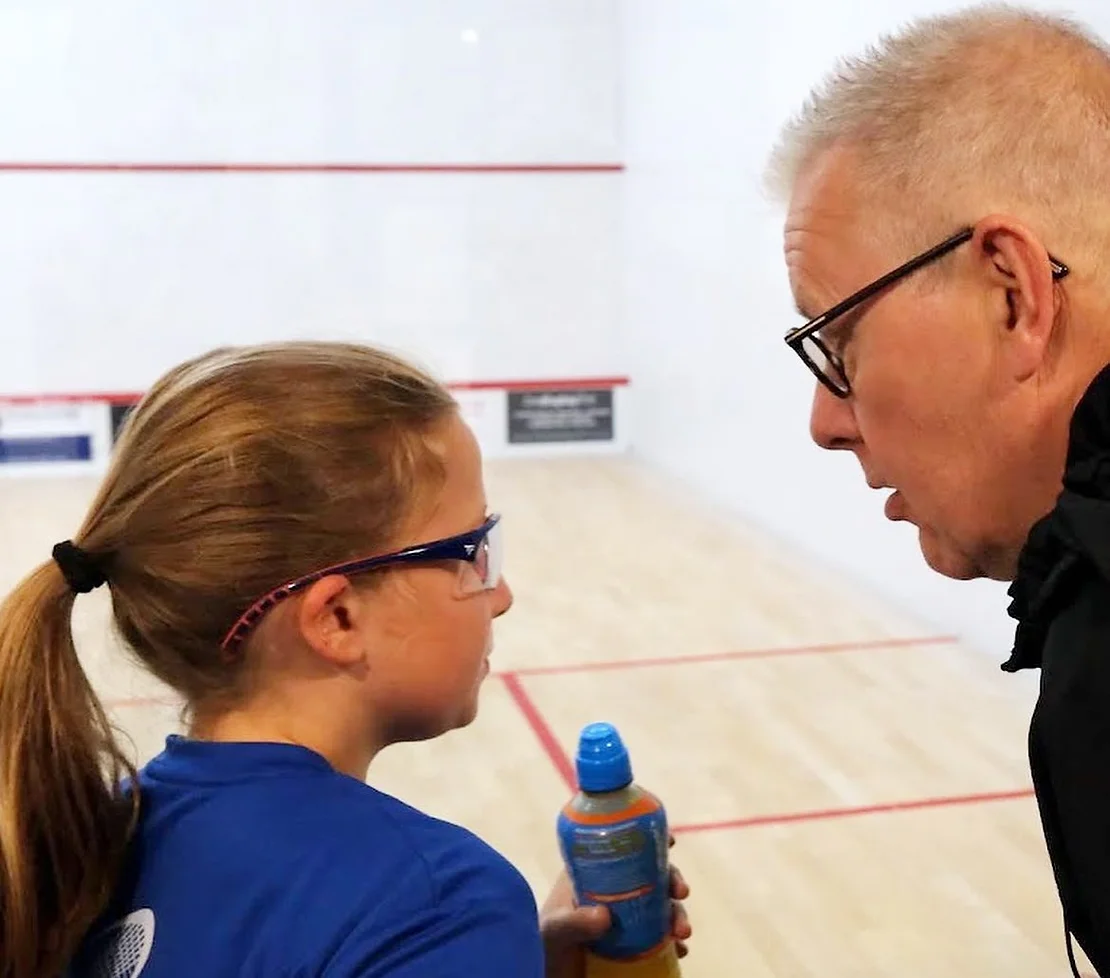 Paul Selby with a junior player at the Off The Wall Squash Academy