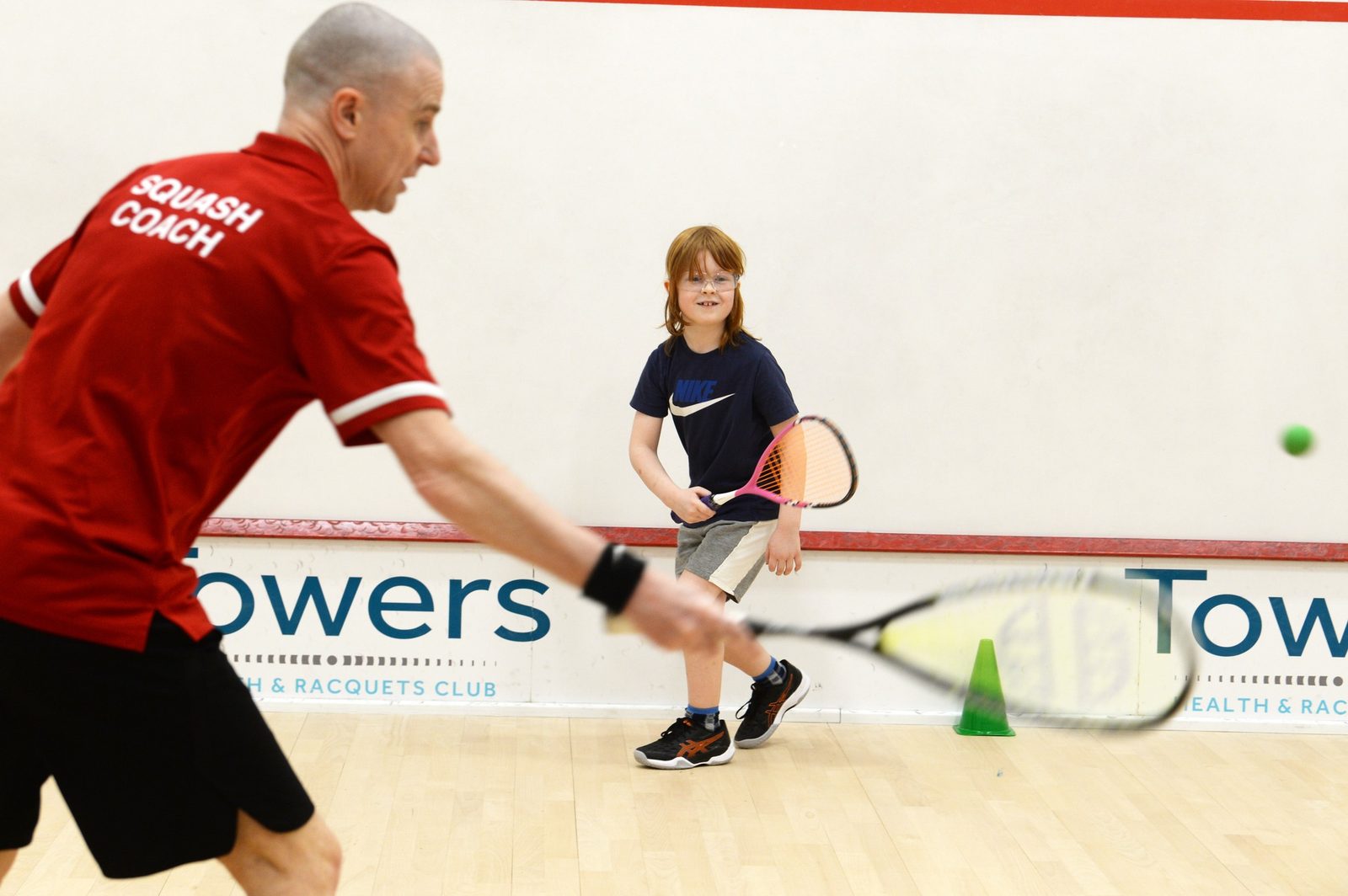 Photo showing the Squash coach of Towers Squash Club with junior player
