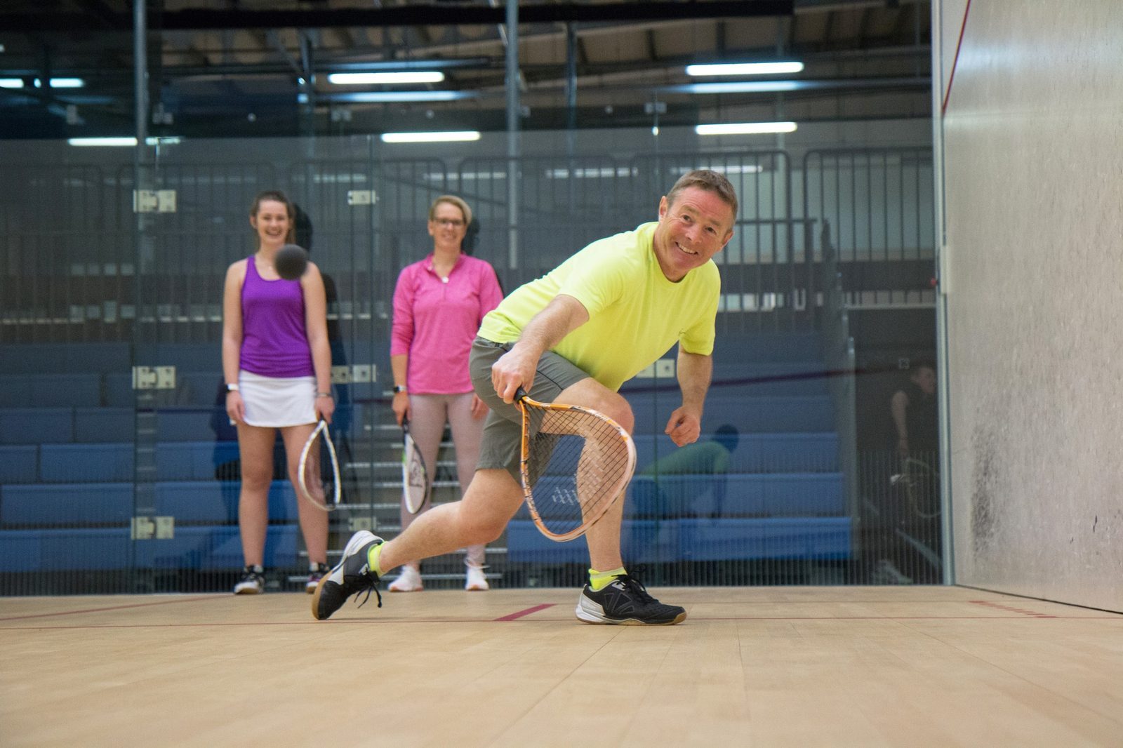 Photo showing coaching lesson of Squash 57 on court