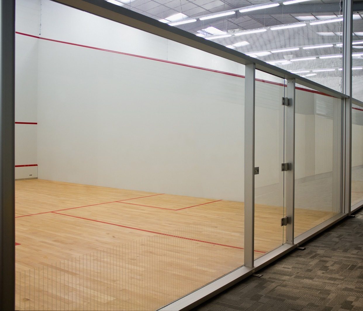 a squash court with frame glas back wall