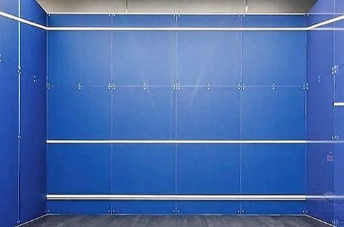 The image shows a squash court with a non transparent glass front wall